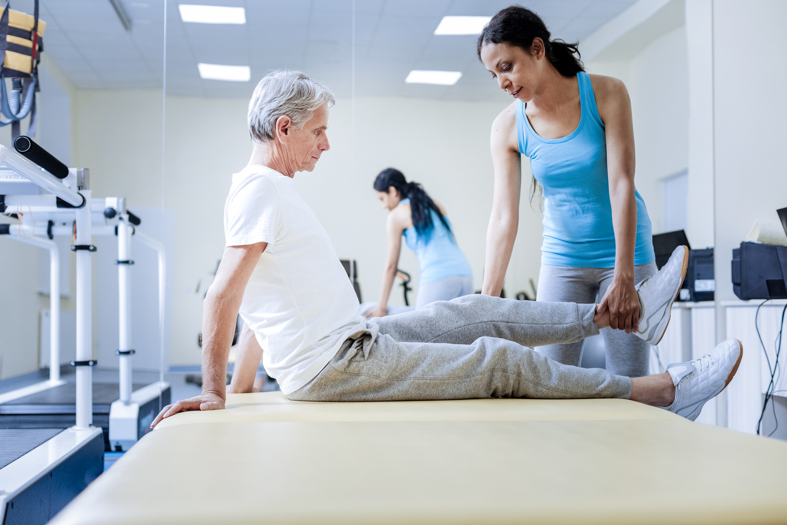 a physical therapist and her client during a session