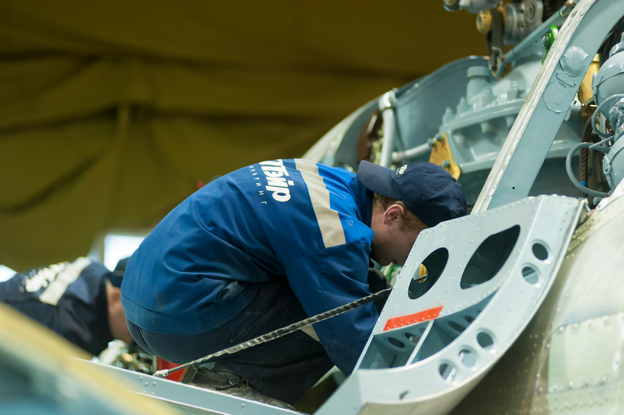 engineer doing maintainance work on a helicopter