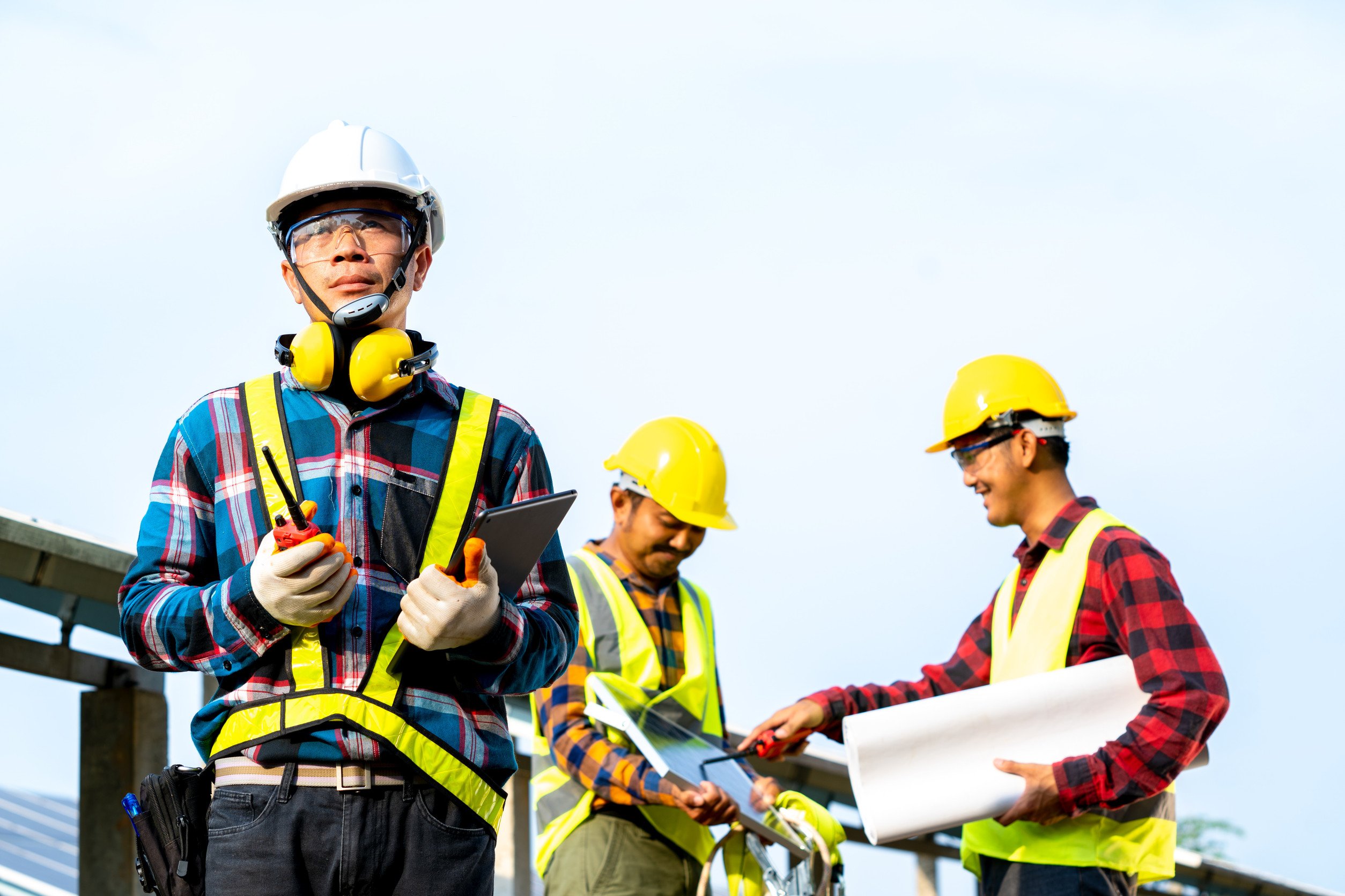 workers on a construction worksite wearing hard hats and high vis gear