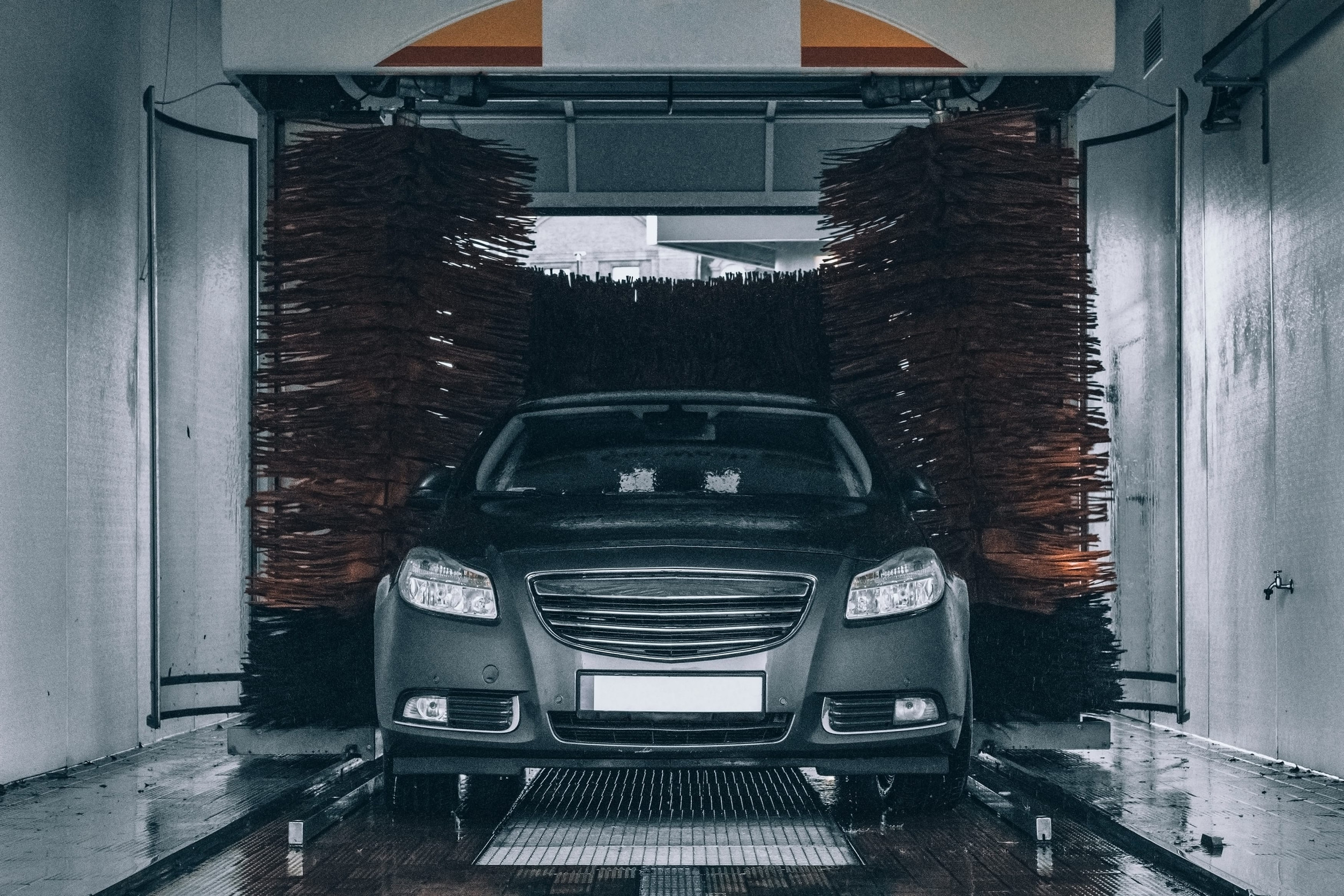 front view of a car moving through an automatic car wash