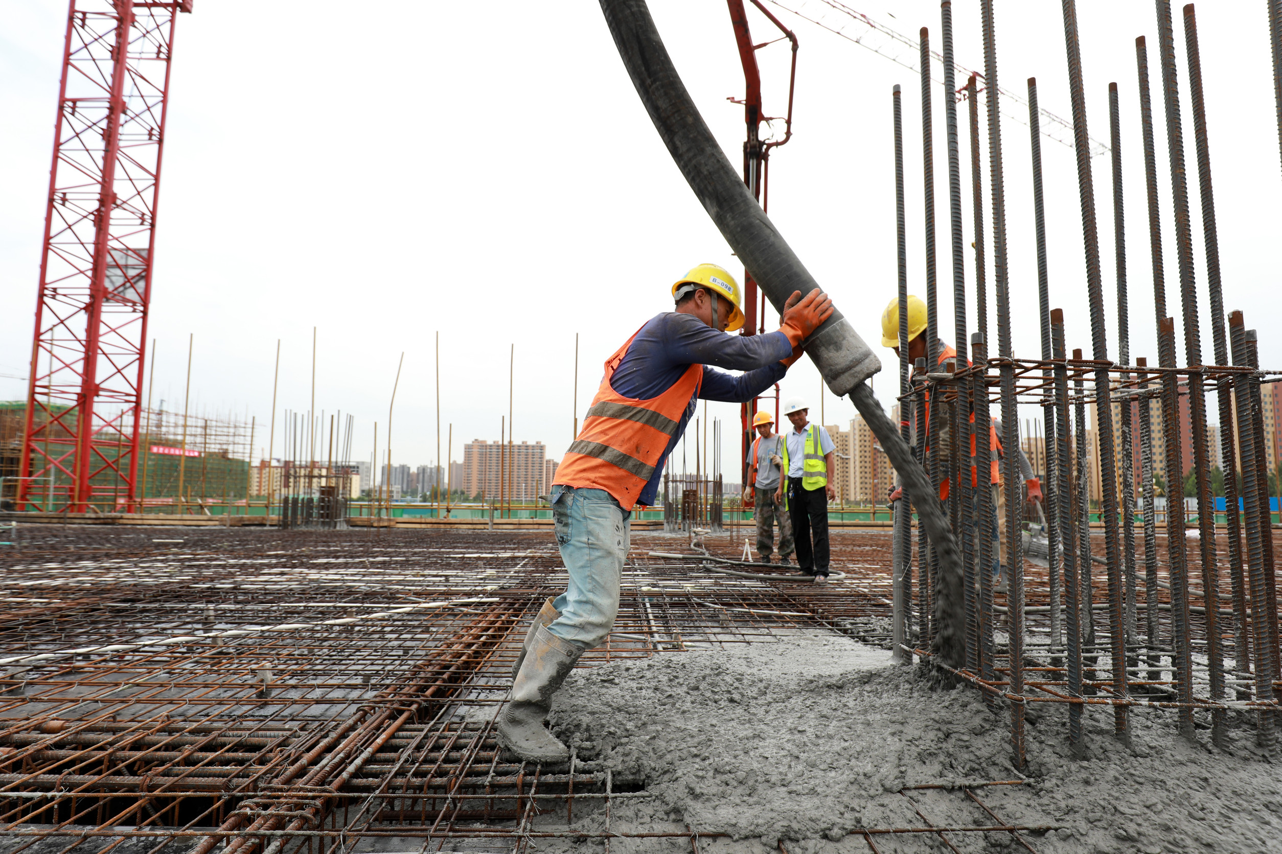 construction workers pouring concrete on a work site