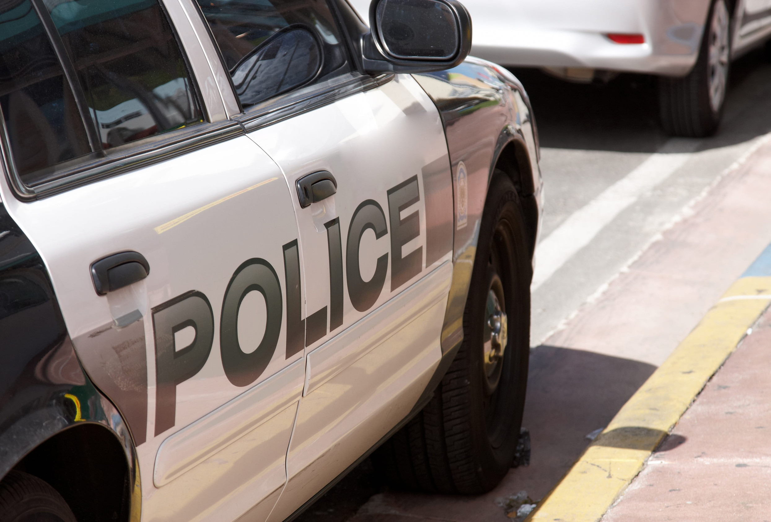 A side view of an American police car parked