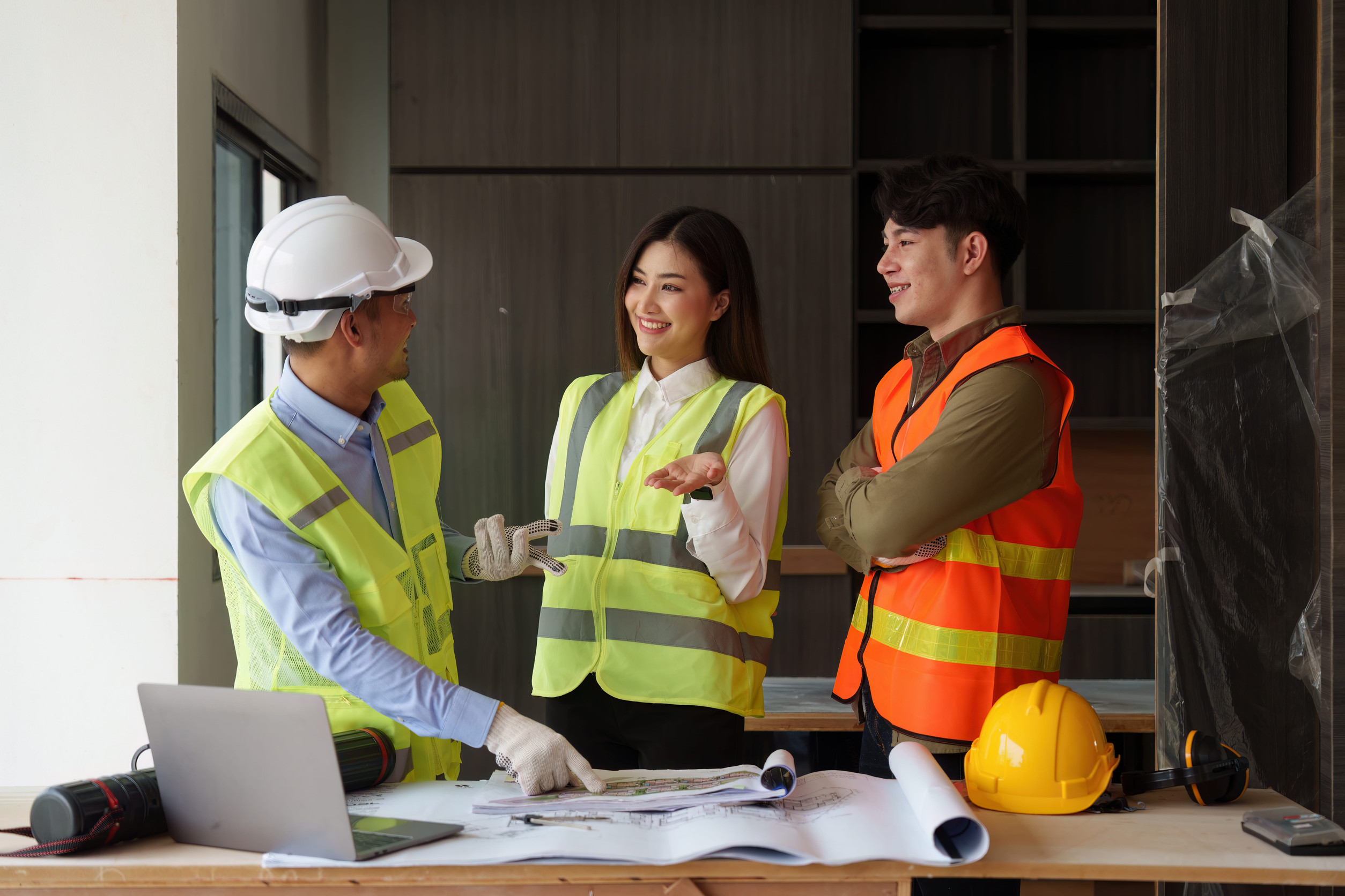Architect and Engineer working with blueprints for architectural plan, engineer sketching a construction project