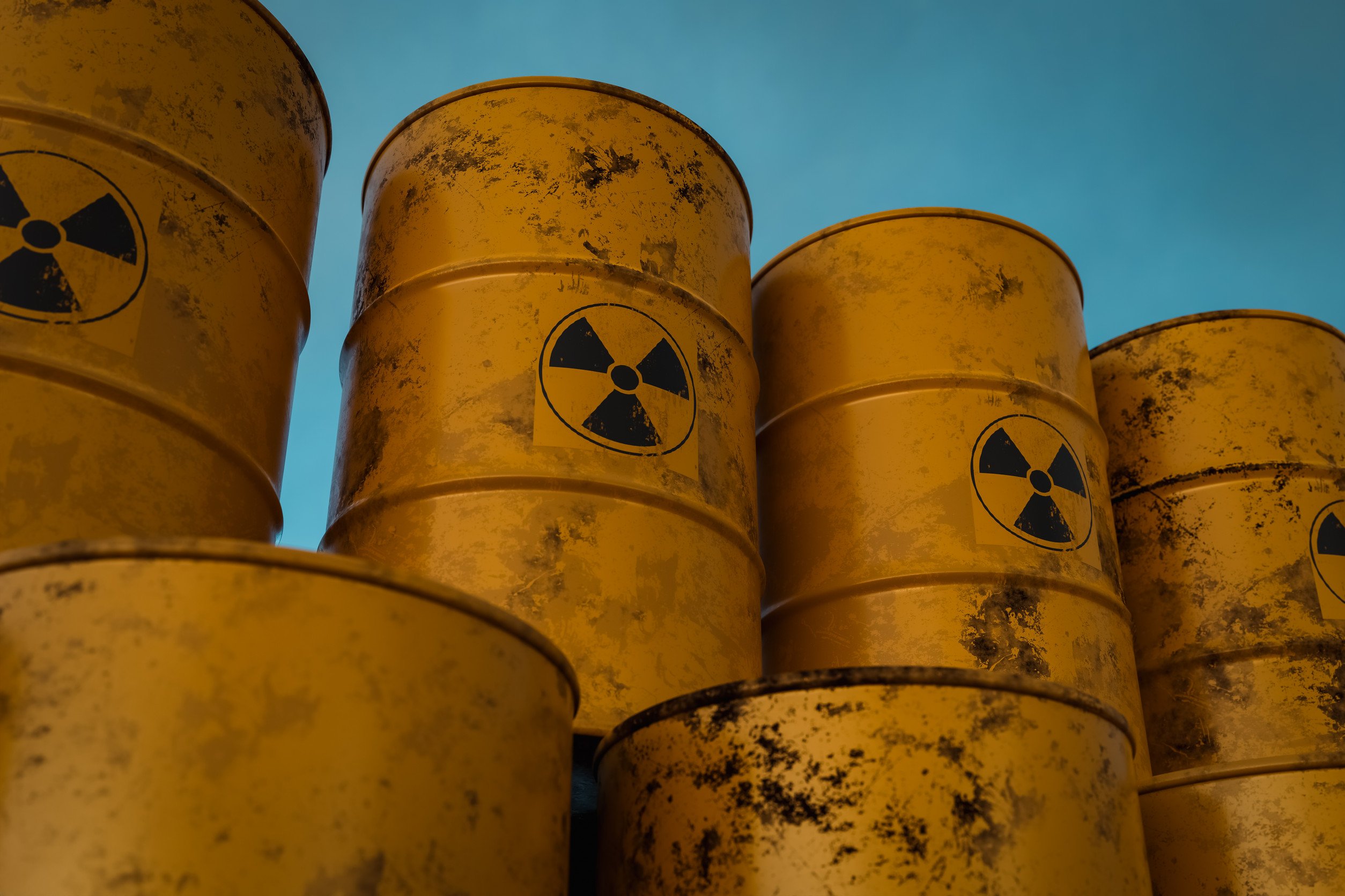 a stack of yellow toxic waste barrels