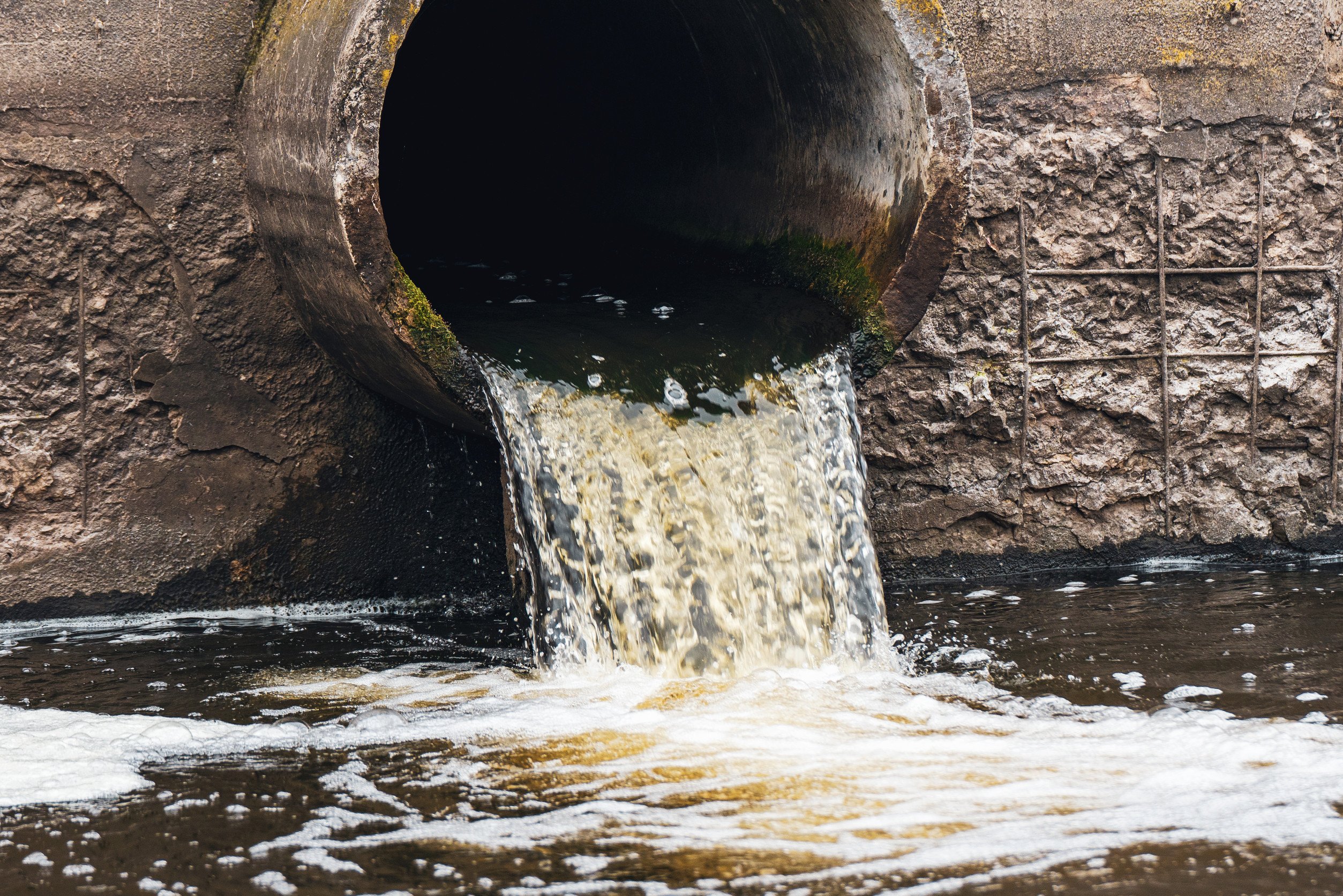 dirty water flows from a sewer pipe