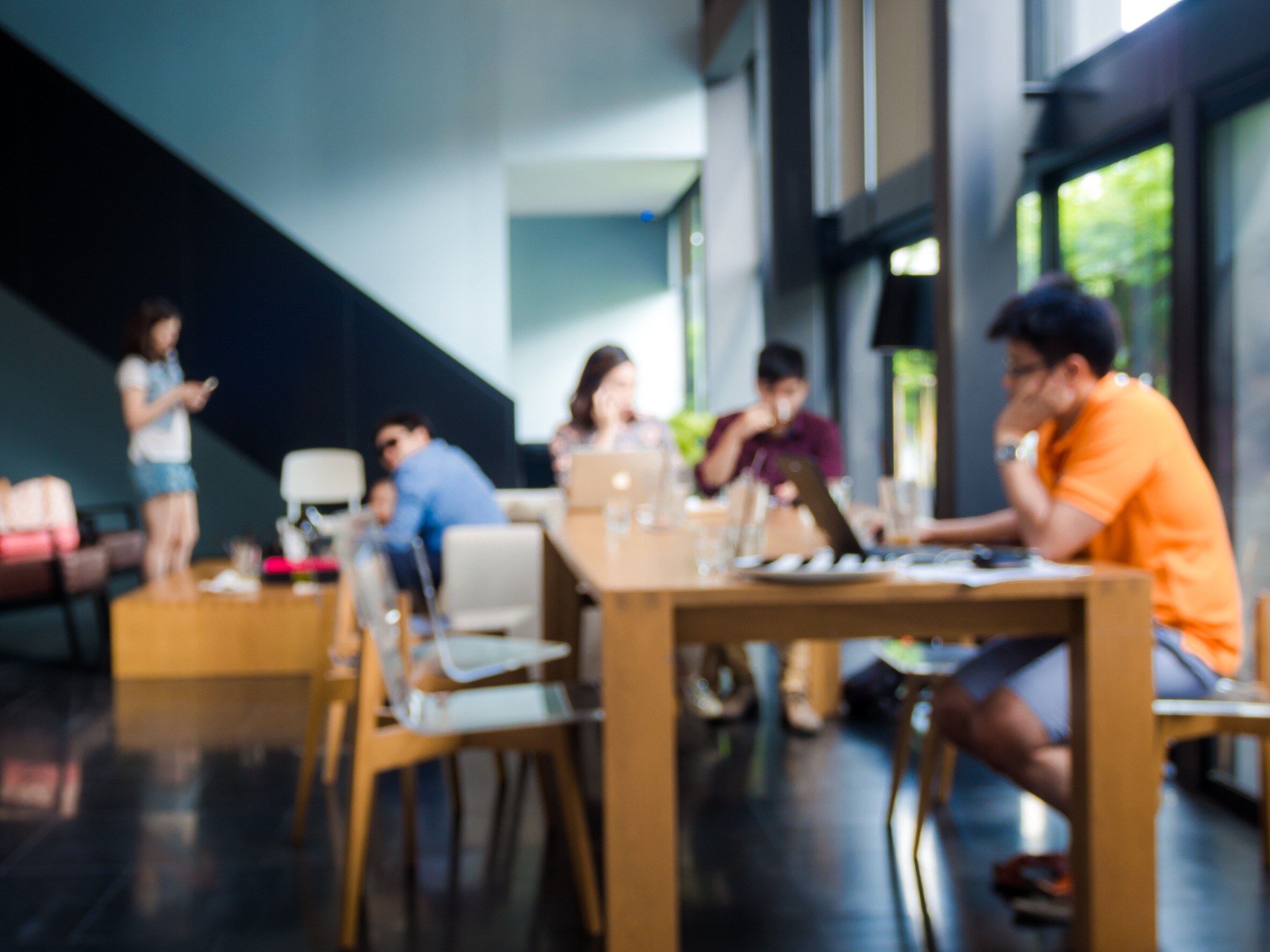 college students eating and studying at university dining hall