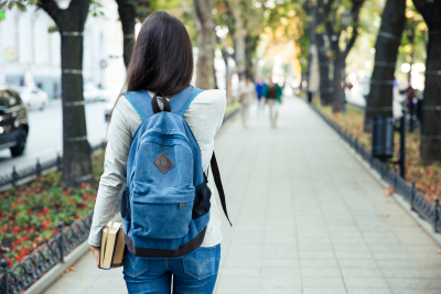 College student wearing backpack facing away from the camera