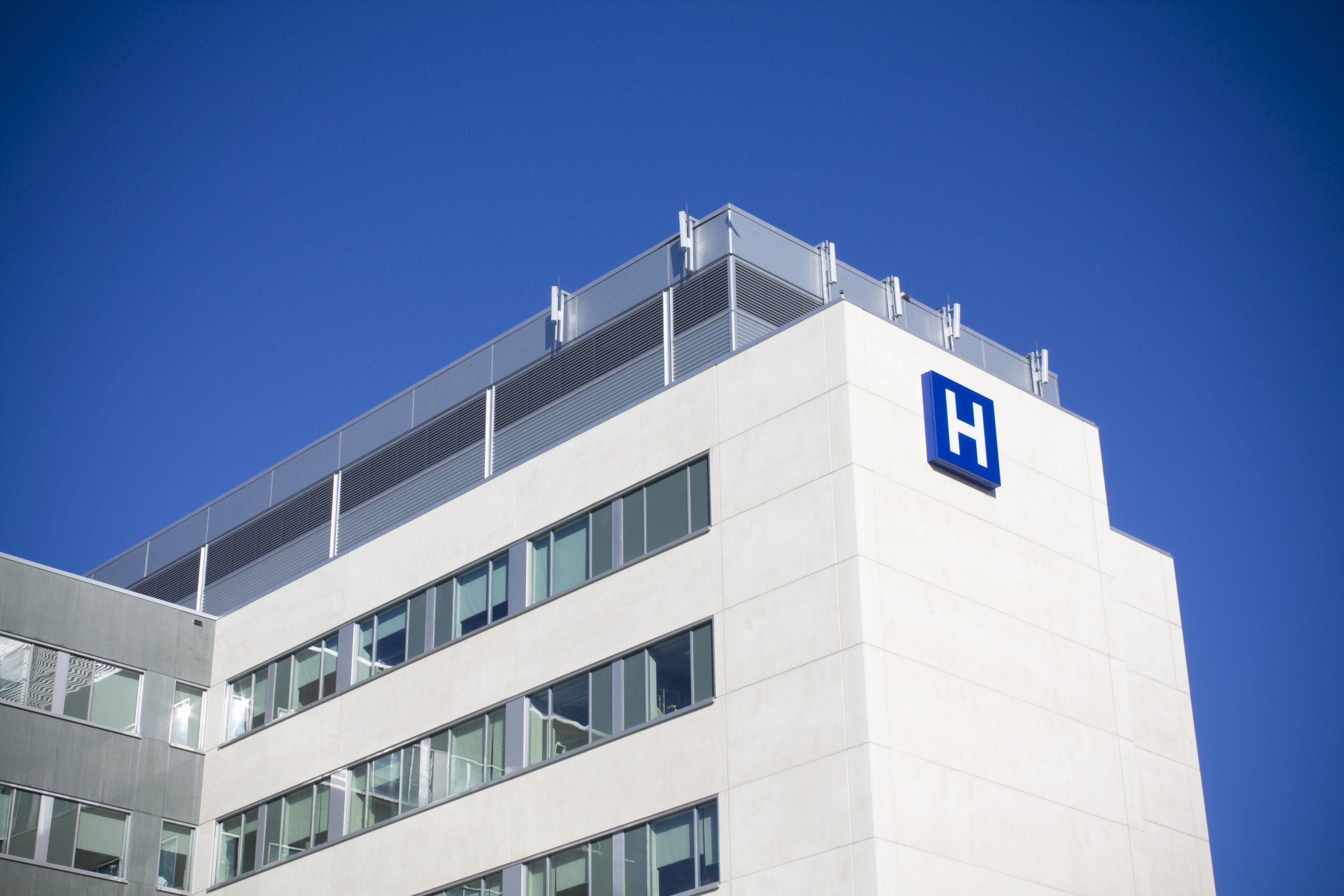 hospital building exterior against a clear blue sky