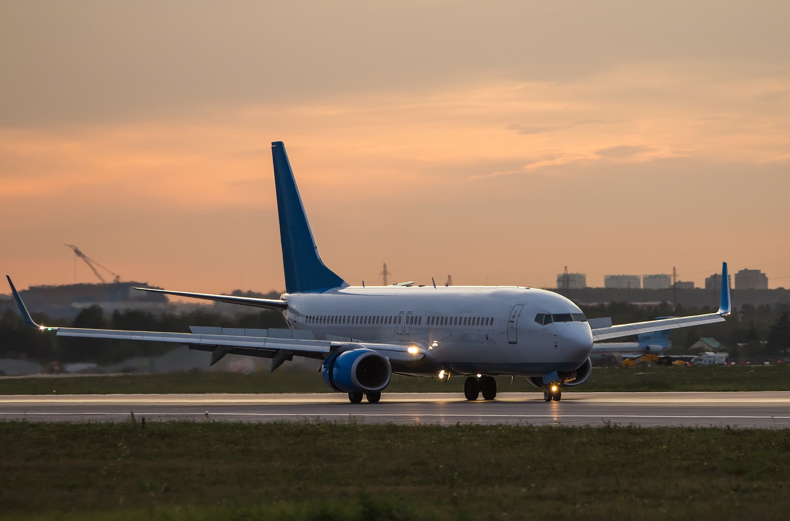 Taxiing aircraft at sunset in the airport
