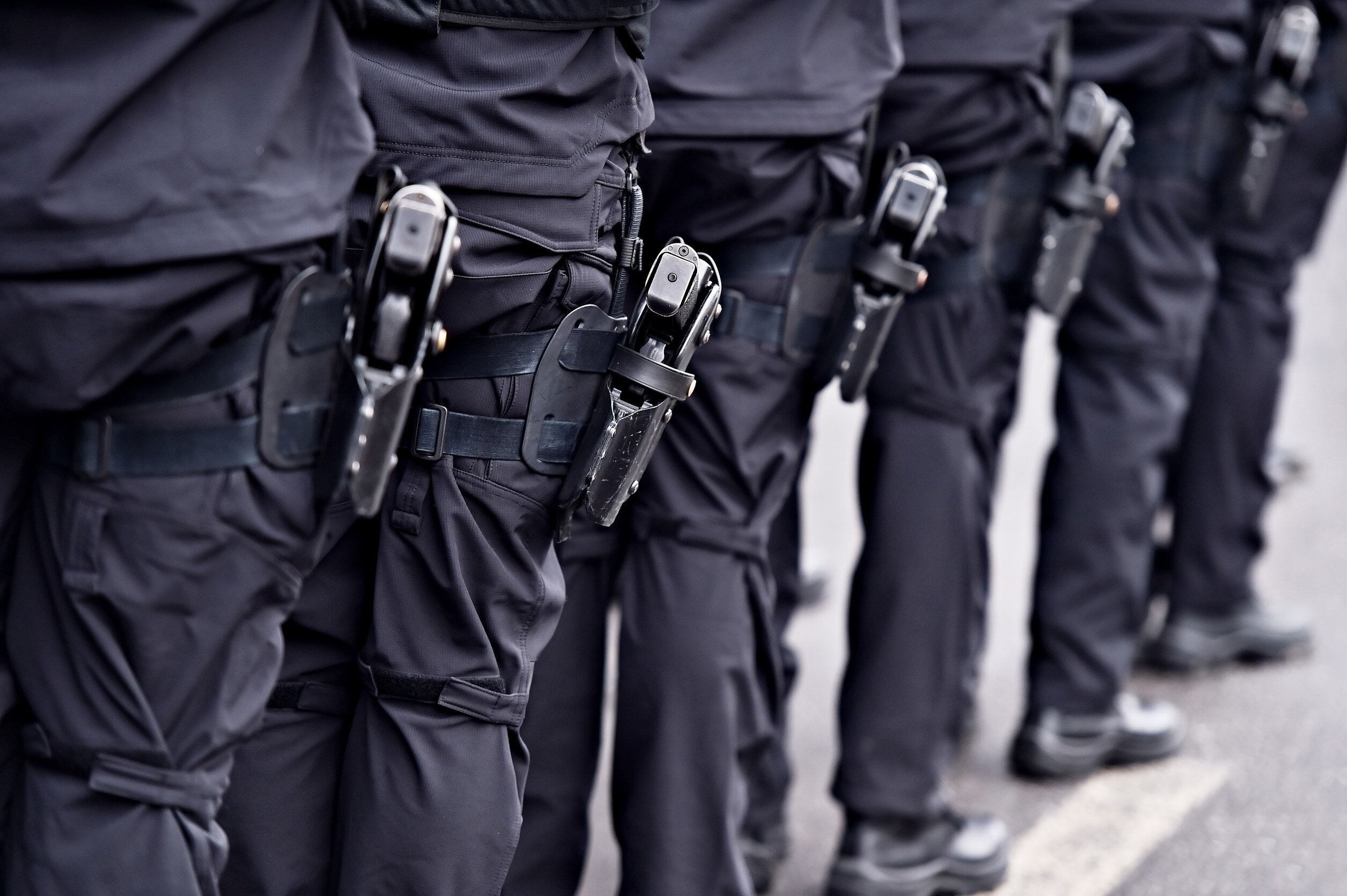 Special forces soldiers with pistols in scabbards during a military parade