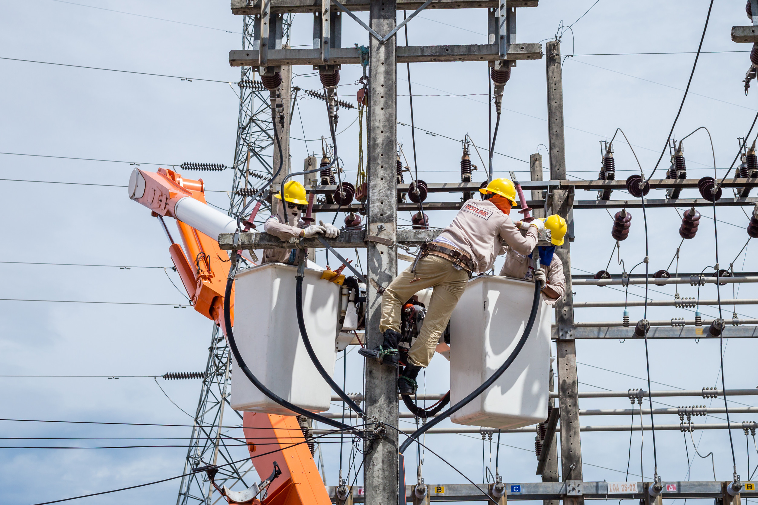electricians repairing a high voltage transmission system