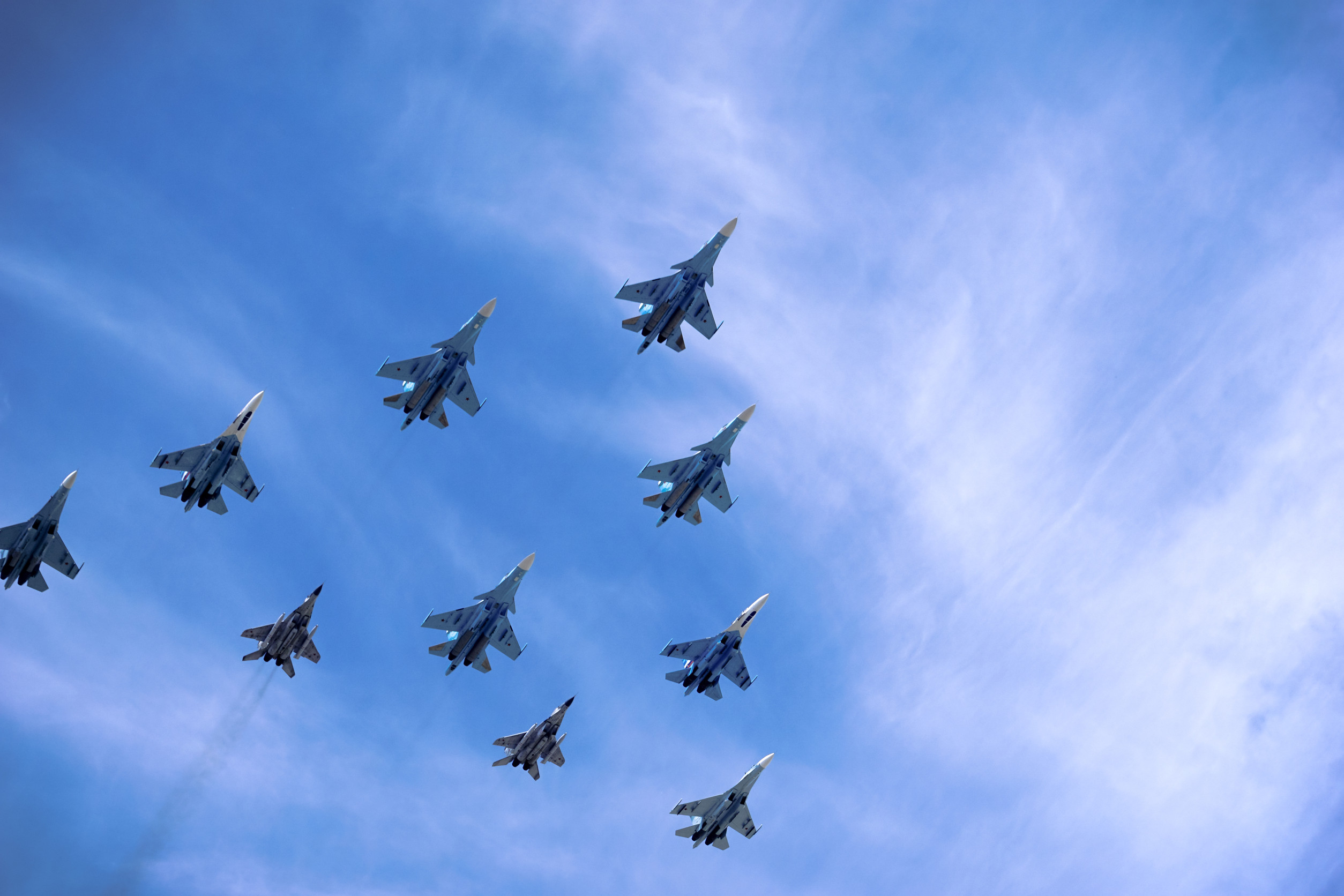 military fighter jets flying in arrow formation