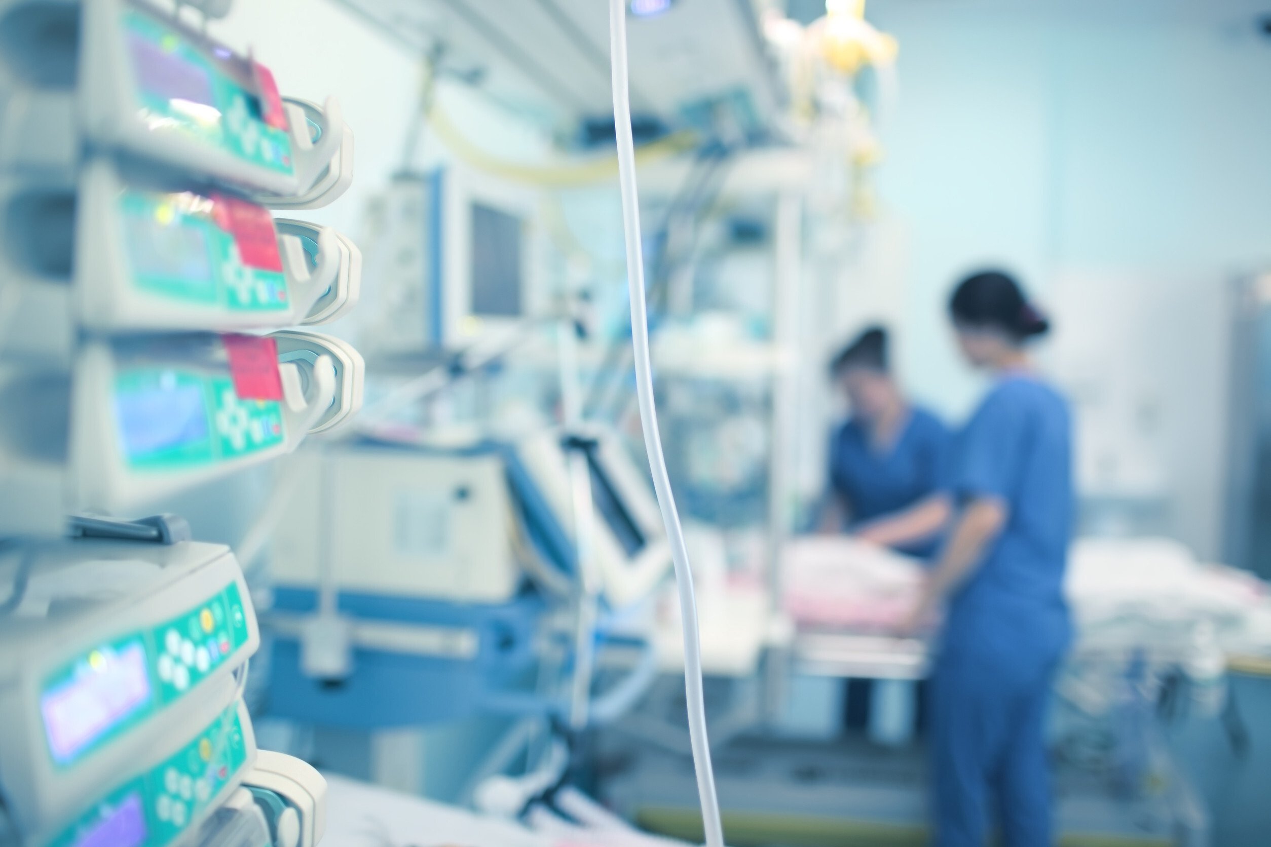 medical staff attending to a patient in a hospital room