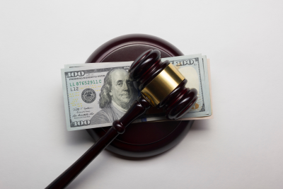Gavel sitting on top of U.S. money.