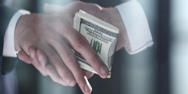 businessman-hand-giving-money-on-black-background