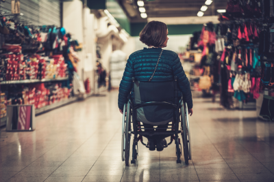 person in wheelchair browsing items in a shop