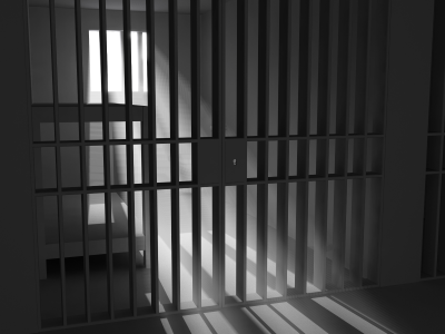 Grayscale image of an empty jail cell.