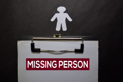 paper on clipboard with the text 'missing person'