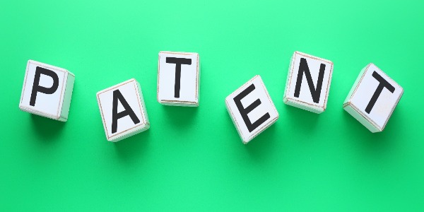 white-cubes-with-word-patent-on-green-background
