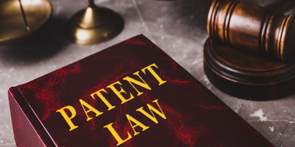 patent-law-book-and-gavel-on-gray-marble-table-closeup