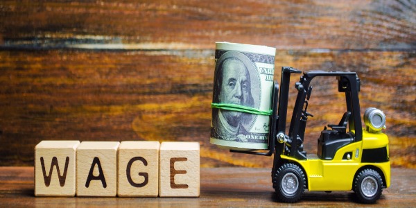 wooden-blocks-with-the-word-wage-dollars-and-a-forklift-financial-compensation-salary-payment