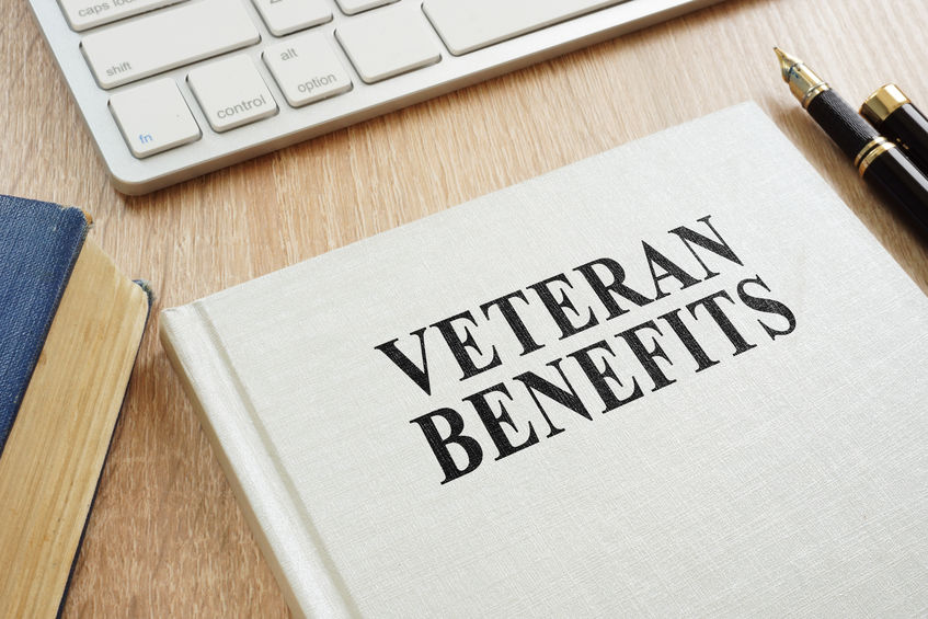 Misuse of Veteran's Funds Keyboard with Veterans Benefits sign