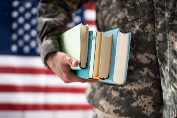Soldier carrying books related to topic Notice of Disagreement | Request for Reconsideration | VA Benefits Law