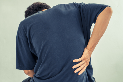 Close up of man holding back in pain