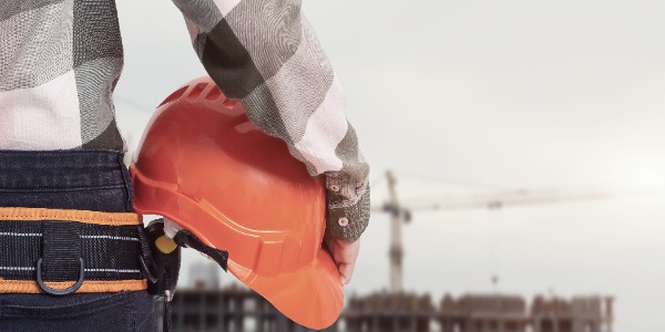 construction-worker-with-safety-helmet-against-city-background