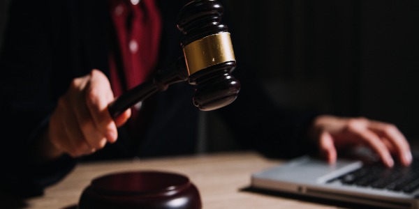 _justice-and-law-concept-male-judge-in-a-courtroom-with-the-gavel-working-with-computer-and-docking