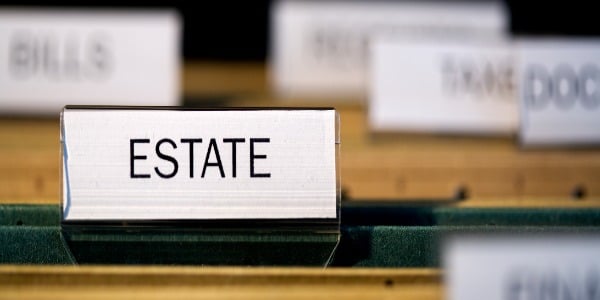 view-inside-filing-cabinet-with-brown-file-folders-green-folder-with-estate-label-in-focus