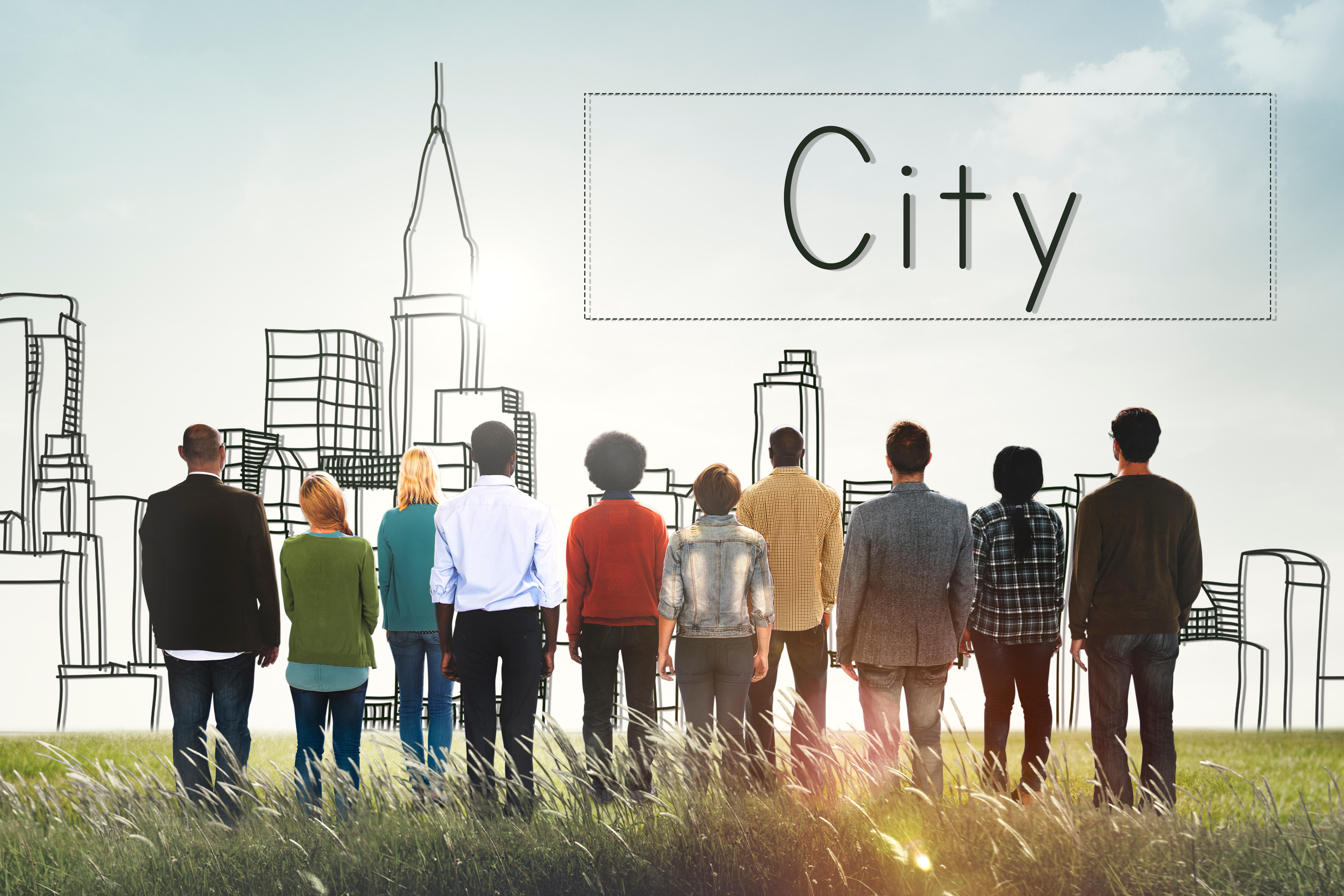 ten people from various background stand in a field facing a hand drawn outline of a city skyline