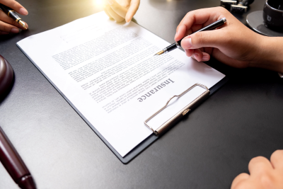 Two people overlooking an insurance document
