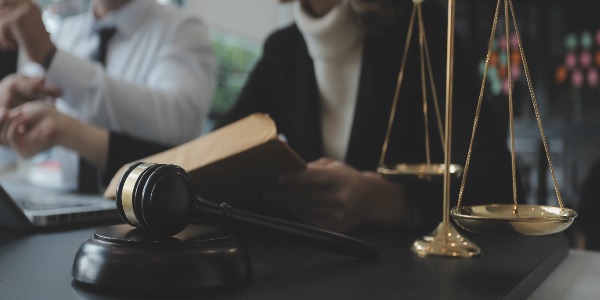 lawyer working with contract papers and wooden gavel on table in a courtroom