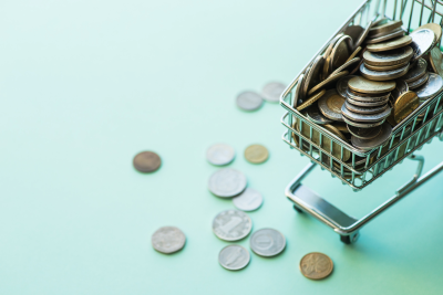 Mini shopping cart overflowing with American coins