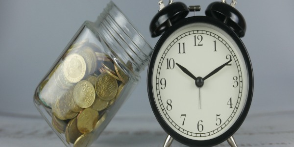 jar-of-gold-coins-and-clock-money-and-time-concept