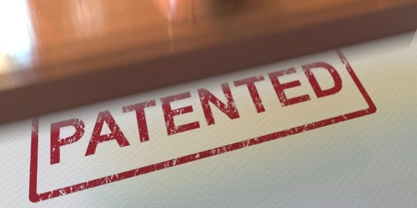 putting-patented-rubber-stamp-on-the-paper-3d-rendering