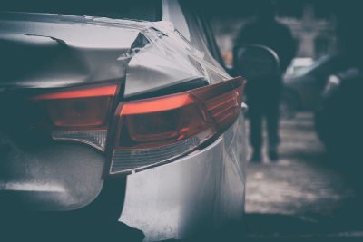 Silver car with damage to trunk and tail lights
