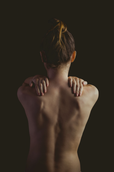 Woman holding both her shoulders
