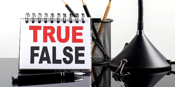 true-false-text-on-notebook-with-pen-and-table-lamp-on-black-background
