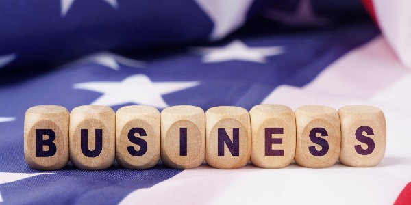 american-economy-and-business-concept-the-us-flag-has-cubes-with-the-inscription-business