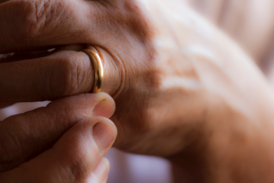 Close up of hands with a golden wedding ring